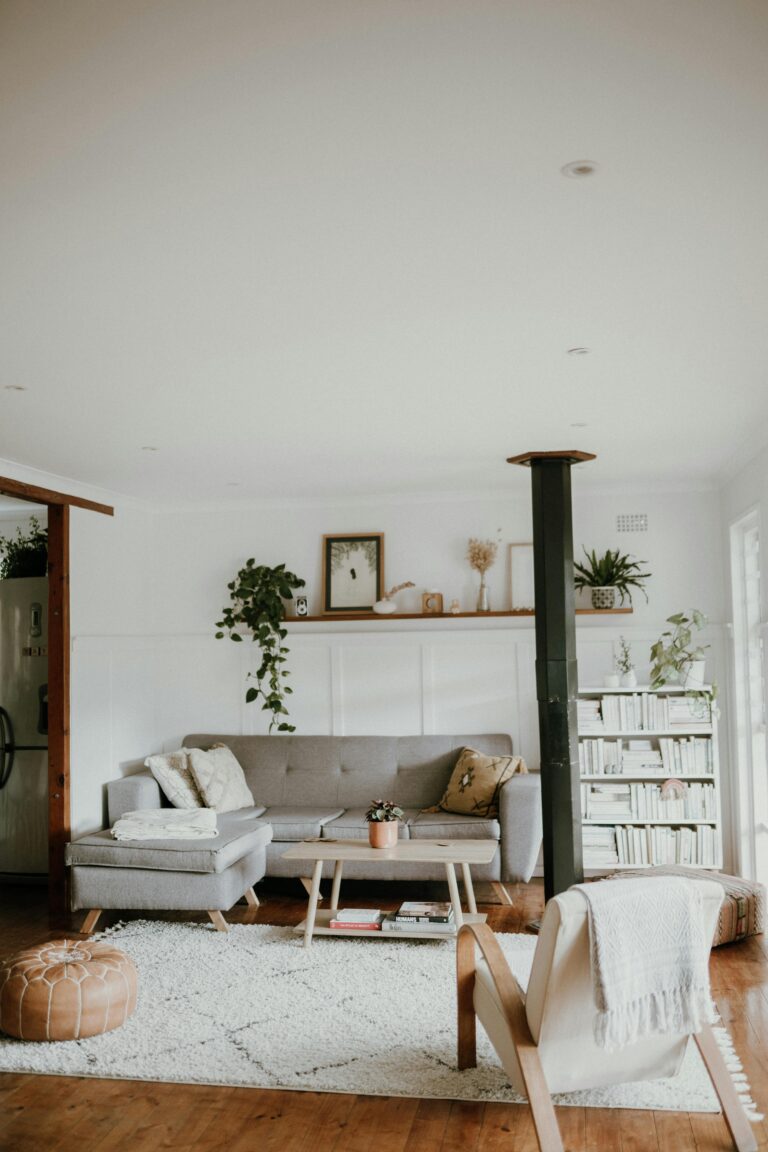 Warm and inviting Scandinavian-style living room with neutral decor and indoor plants.